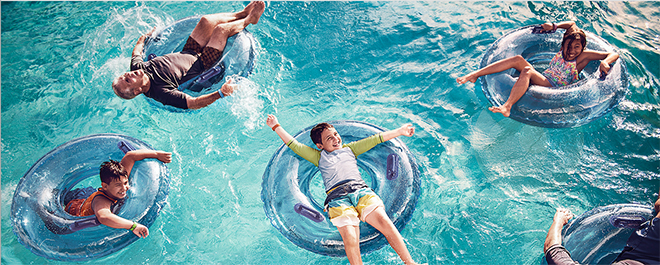 Five Guests float on inner tubes in a pool
